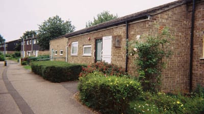 Exterior view of a senior living building with garden