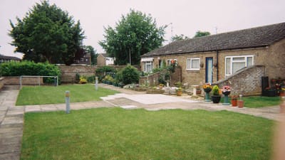 Outdoor garden area with flower pots and grassy space
