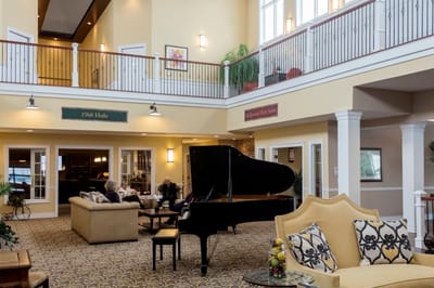 Common area with residents and a grand piano