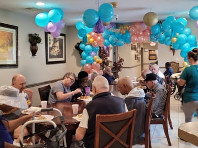 Residents enjoying a meal at a birthday celebration
