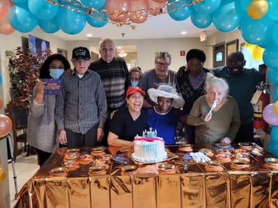 Residents and staff celebrating a milestone birthday together