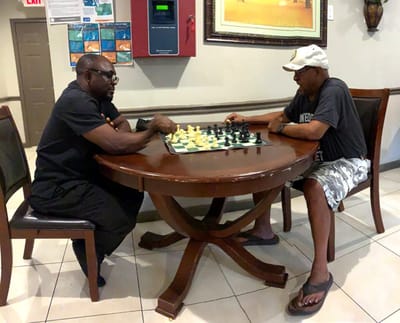 Two men playing chess in a common area