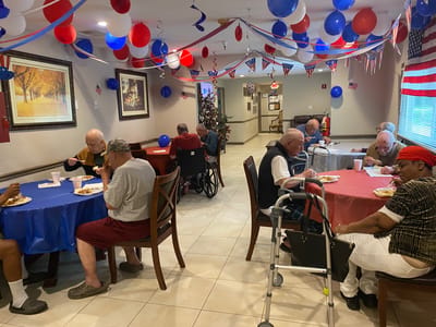 Residents enjoying a meal in a festive dining area