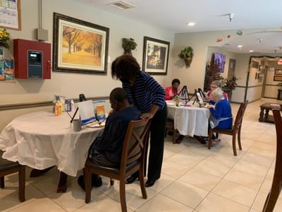 Residents engaging in an art activity in the common area