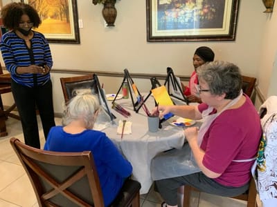 Residents engaged in a painting activity in a common area