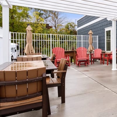 Outdoor patio area with red and brown chairs