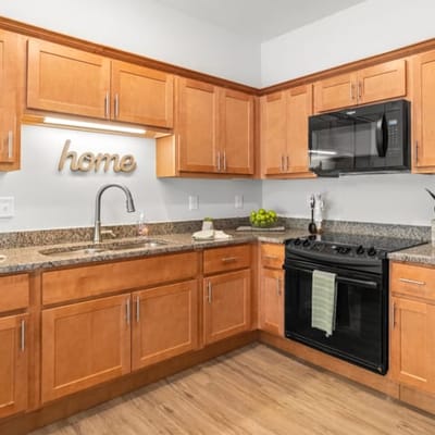 Modern kitchen area with wooden cabinets and a cozy vibe