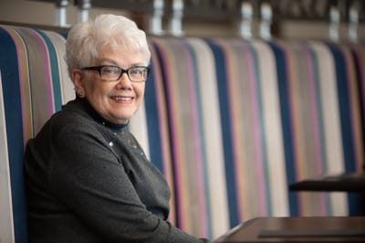 Senior resident smiling in a cozy interior space