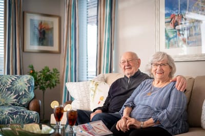 Happy couple sitting together in a cozy common area