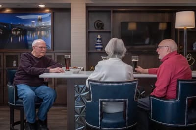 Residents enjoying drinks in a stylish lounge