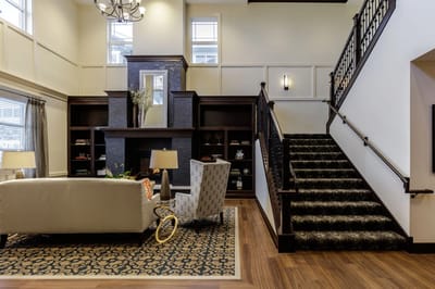 Spacious common area with seating and staircase