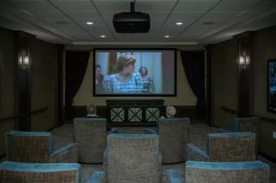 Residents watching a movie in a cozy theater