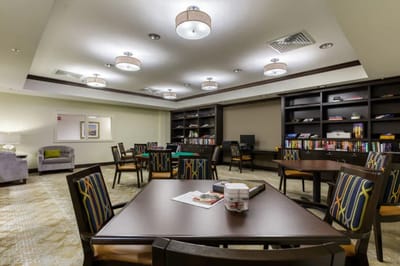 Bright common area with tables and bookshelves