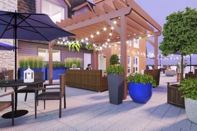 Outdoor lounge area with comfortable seating and plants