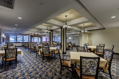 Dining area with tables and chairs set for meals