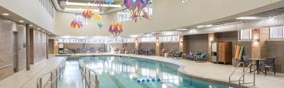 Bright indoor swimming pool area with vibrant decor