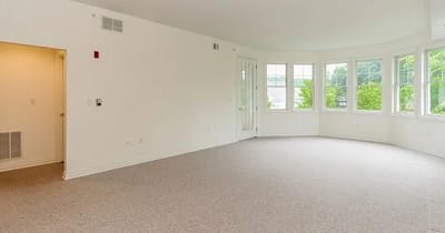 Spacious interior view of a room with windows