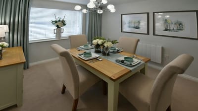 Bright dining room with table set for meal