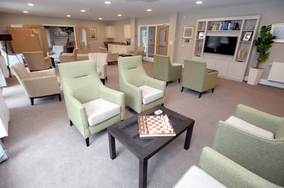 Common area with chairs and chessboard in a senior living facility