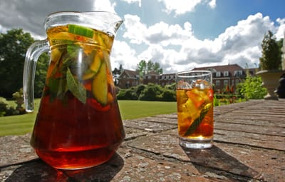 Refreshing beverage on a patio with a garden view