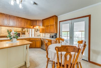 Welcoming interior kitchen with wooden cabinets and dining table