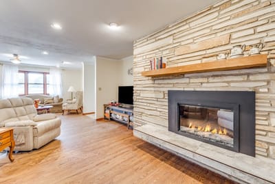 Cozy living room with fireplace in senior care facility