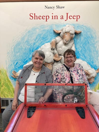 Two residents posing in an activity area
