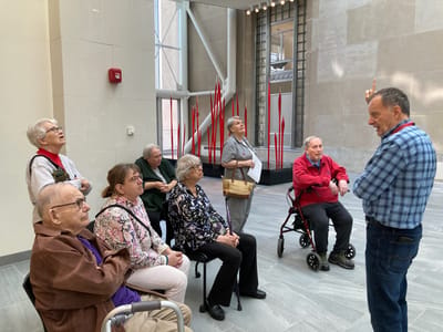Residents listening to a speaker in a common area