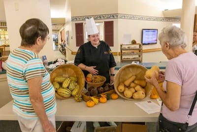 Residents engaging with a chef at a food event