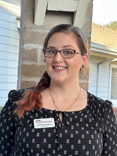 Staff member smiling in an outdoor setting