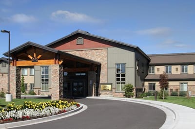 Exterior view of Fairfield Village facility with landscaping