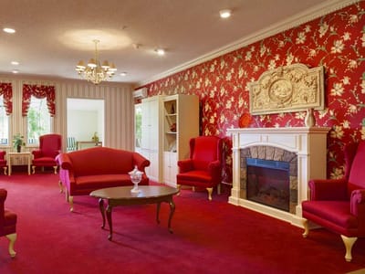 Interior common area with red floral wallpaper and seating