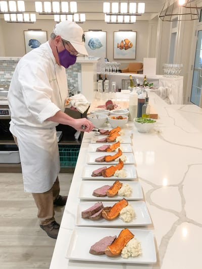 Chef plating meals in a dining area