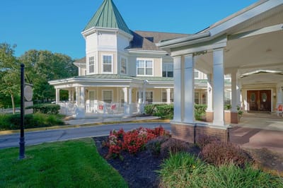 Exterior view of a senior living facility with gardens