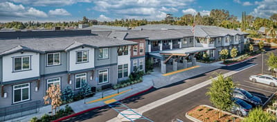 Exterior view of Allara Senior Living facility with landscaped entrance