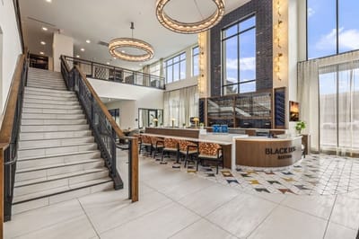 Bright and modern lobby area with seating and a staircase