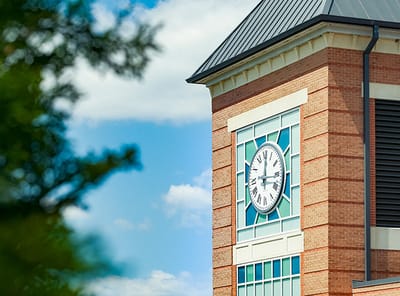 Clock tower on the building exterior against a blue sky