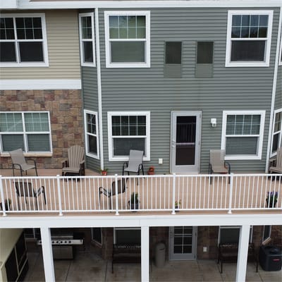 Aerial view of apartment balconies with chairs.