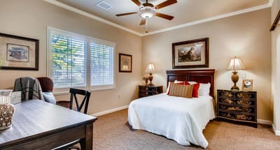 Cozy interior of a private resident room with a bed and desk