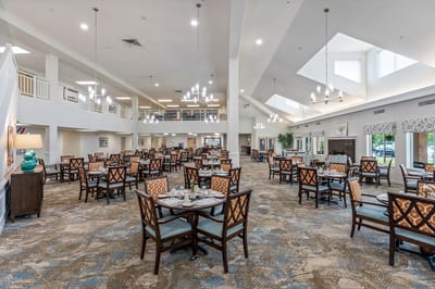 Dining area with tables and chairs arranged for residents