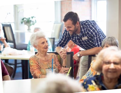 A staff member engaging with a resident in a common area