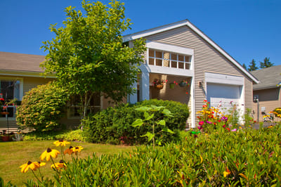 Exterior view of the facility with flowers and trees