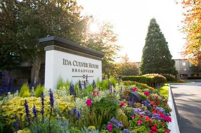 Entrance sign of Ida Culver House Broadview with flowers