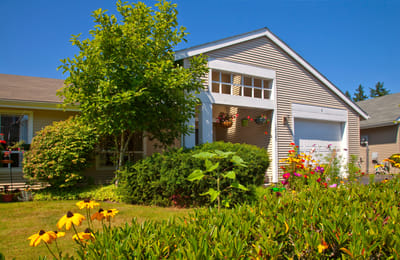 Exterior view of a senior living facility with flowers