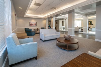 Common area with seating and artwork in a senior living facility