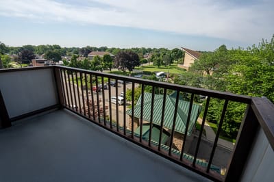 View from a balcony overlooking a green landscape