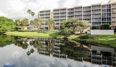 Exterior view of the Sun Towers Retirement Community by a lake