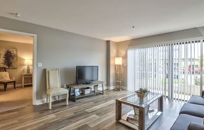 Bright interior common area with seating and television