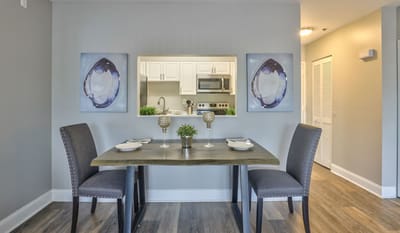 A well-decorated dining area with a table and chairs