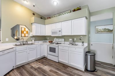 Bright, airy kitchen area with white cabinets